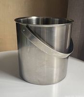 Side view showing cylindrical form and handle