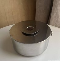 Top view showing satin stainless lid with central teak insert