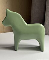 Left side view of green ceramic Dala horse figurine