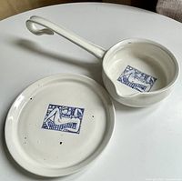 Plate and handled pan showing blue motif and overall glazing