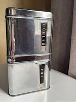 Front view of stacked Coffee and Tea canisters showing chrome finish and label panels