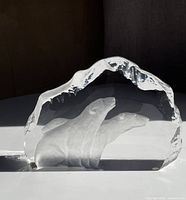 Front view of clear glass sculpture showing two etched polar bears