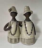Front view of Elsi Bourelius ceramic figurine showing both figures, necklaces, hats, glaze and texture
