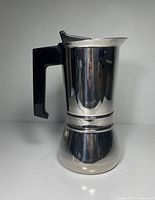 Right side view of stainless steel Vev Vigano moka pot showing handle profile and overall form