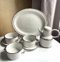 Group view showing platter, coffee pot, three soup bowls, two saucers