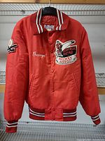 Front view of red Avon Sportswear quilted jacket showing patches and striped trim
