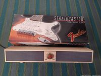 Front of Ligno speaker beneath boxed Fender 1:3 Stratocaster replica
