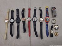 Group shot of all 13 wristwatches laid out side by side