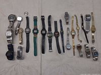 Full layout of all wristwatches and parts on table