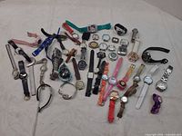Group shot showing all wristwatches laid out on surface