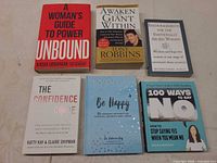 All six books front covers visible on flat surface