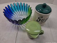 Lot overview showing glass bowl, sugar canister, mug with lid.