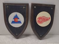Front view of both wall plaques showing logos and condition