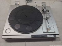 Top view of Sony PS-LX210 turntable showing platter, tonearm, controls, dust cover lid open