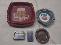 Group shot showing all three ashtrays and two lighters