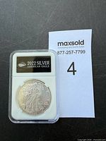 Front of plastic-encased 2022 Silver American Eagle coin showing obverse Walking Liberty design and label
