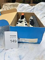 Shoes in original blue Adidas box with size label visible
