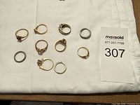 All ten costume rings laid out showing metal tones and settings