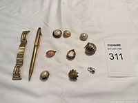 Full layout: watch band, pen, nine jewelry pieces