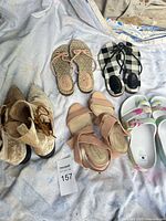 Five footwear pairs arranged on sheet – overall lot view