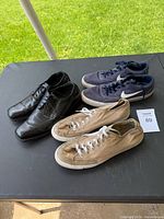 All three pairs of shoes on table