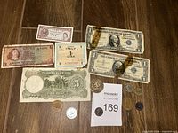 Overview of all banknotes and coins on wooden surface