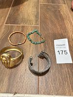 Group shot of four bracelets on wooden surface