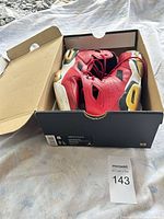 Sneakers inside original Nike box showing size label