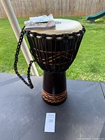 Full view of djembe on table showing overall condition