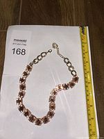 Full view of necklace beside ruler showing length and extender chain