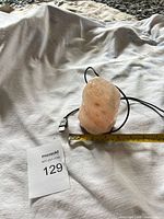 Full view of salt lamp with USB cable, tape measure showing height