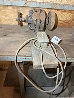 Full view of buffer on wooden plank with switch and cord