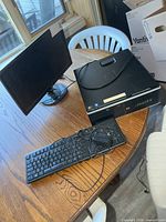 Asus monitor, HP desktop, Dell keyboard on table