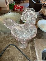 Full view of pink glass rooster candy dish assembled