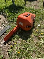 Entire closed Stihl chainsaw case laying on grass