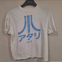 Front view of white Atari logo T-shirt on hanger