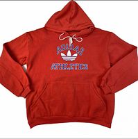 Front view of red Adidas Athletics Trefoil hoodie, hood up, kangaroo pocket visible