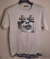 Front of heather white Pink Dolphin T-shirt on hanger showing graphic design