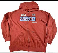 Front view of red Volcom full-zip hoodie showing patches, zipper, pockets