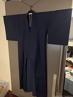 Full view of navy blue kimono hung to show overall shape