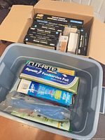Plastic tote with foil box, Ziploc bags, and shipping carton full of bulb boxes