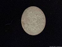 obverse view of worn silver coin