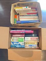 Two open boxes showing full assortment of books