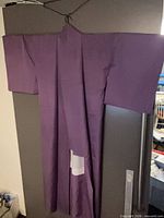 Front view of full-length purple kimono on hanger