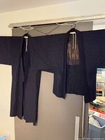 Full view of both garments hanging side by side