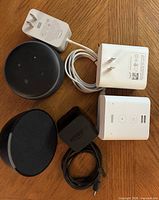 All devices and power adapters laid out on table