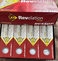 Closed Dunlop Revelation Distance golf ball box showing four inner sleeves, branding and high-velocity core claim