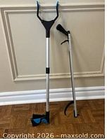 Both reacher tools standing upright showing full length and ends