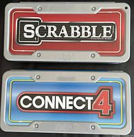 Scrabble and Connect 4 travel cases closed showing front logos