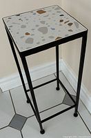 Angle view of full plant stand showing frame and tile top